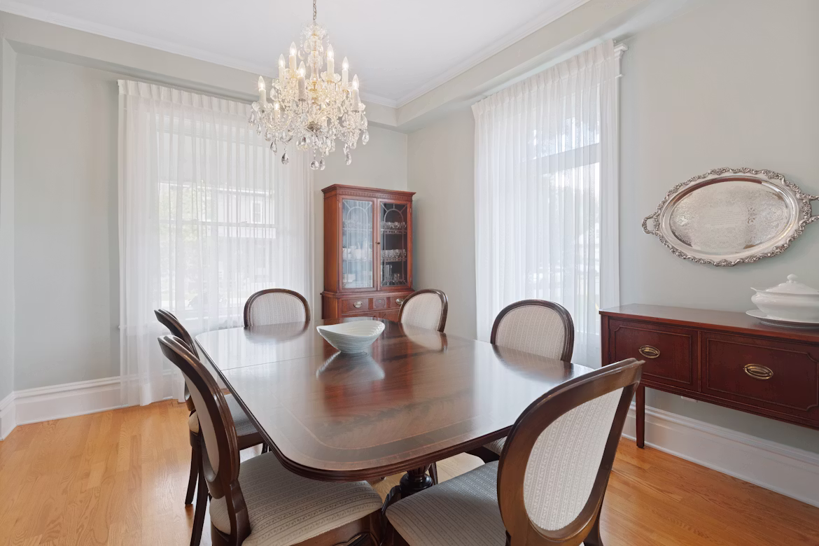 A restored walnut dresser styled in a warm period dining room