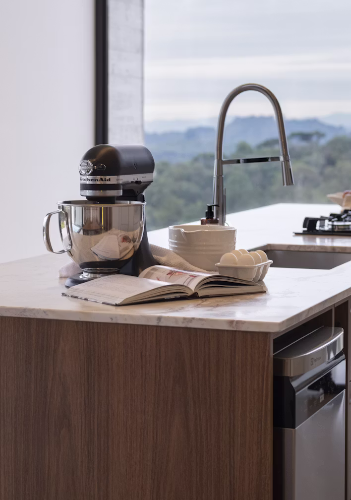 A solid walnut kitchen island in a sunlit period kitchen